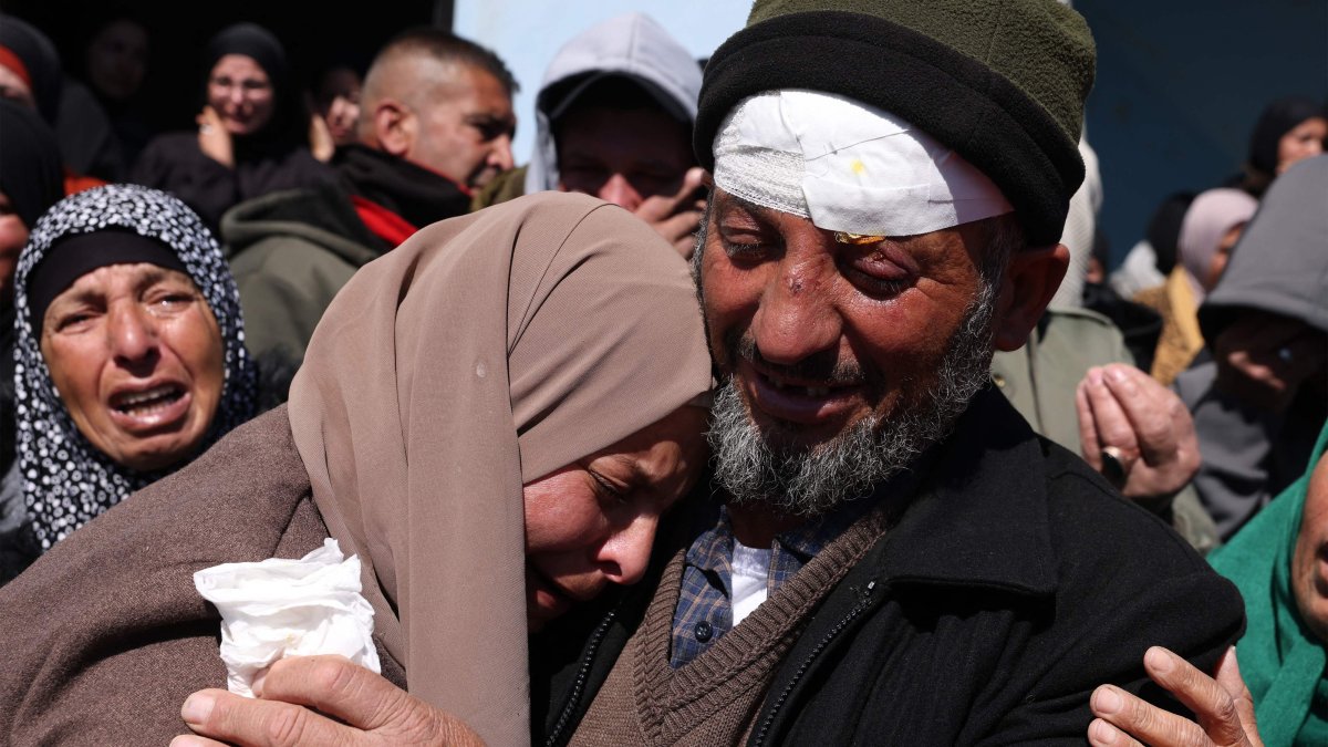 Mohammed Shannaran mourn over the body of his son Ameer Shannaran with family at his funeral in Yatta village in Hebron, occupied West Bank, Palestine, March 8, 2026. (AFP Photo)