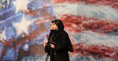 People walk past an anti-U.S. billboard in Tehran, Iran, Jan. 26, 2026. (Reuters Photo)