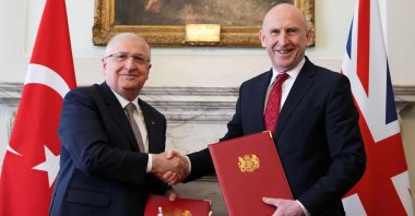 British Defense Secretary John Healey (R) and Defense Minister Yaşar Güler (L) shake hands after signing an agreement that allows Türkiye to purchase 20 Eurofighter Typhoon jets, London, U.K., March 25, 2026. (AFP Photo)