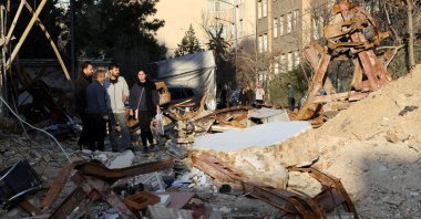 People look at a destroyed building following a strike, amid the U.S.-Israel-Iran war, Tehran, Iran, March 21, 2026. (Reuters Photo)