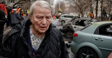 A resident walks at the site of a Russian drone strike, amid Russia's attack on Ukraine, in Kharkiv, Ukraine, March 25, 2026. (Reuters Photo)