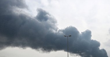 Smoke rises from the area of the Kuwait International Airport after a reported drone strike hit a fuel depot on March 25, 2026. (AFP Photo)
