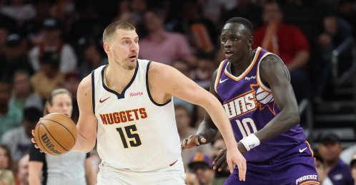 Denver Nuggets' Nikola Jokic handles the ball against Phoenix Suns' Khaman Maluach during the first half of the NBA game at Mortgage Matchup Center, Phoenix, U.S., March 24, 2026. (AFP Photo)
