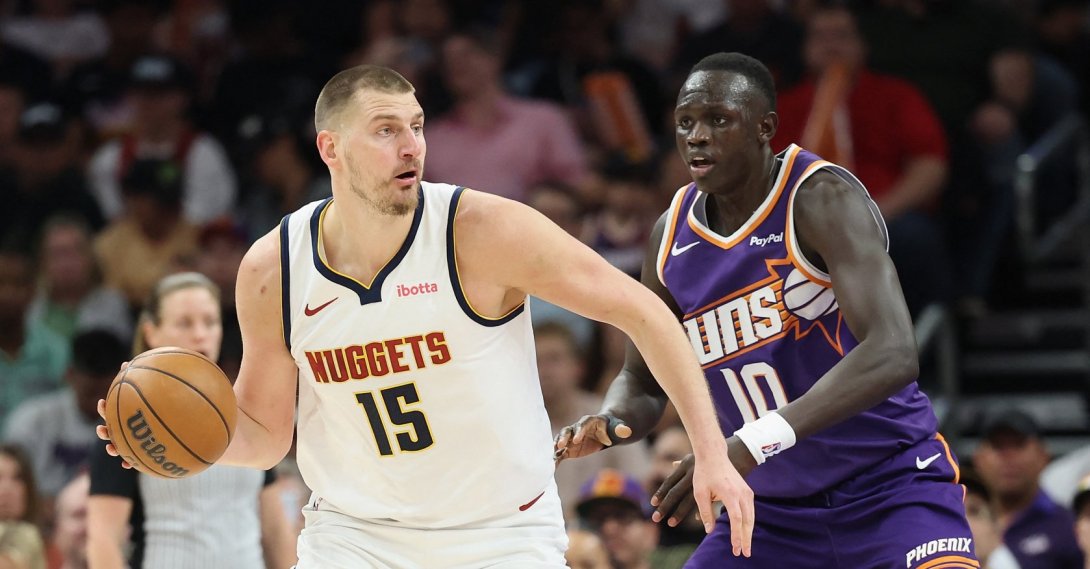 Denver Nuggets' Nikola Jokic handles the ball against Phoenix Suns' Khaman Maluach during the first half of the NBA game at Mortgage Matchup Center, Phoenix, U.S., March 24, 2026. (AFP Photo)
