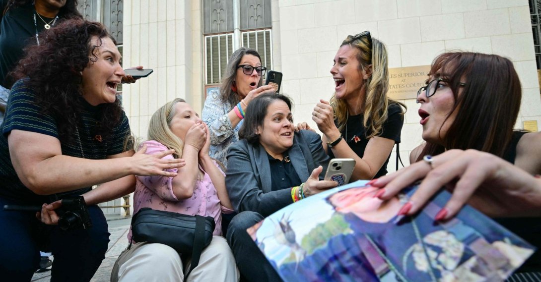 Laura Marquez-Garrett, plaintiffs' attorney for SMVLC (Social Media Victims Law Center), gathers with family members of victims as they react to news that the jury has found Meta and YouTube liable in the social media addiction trial, outside the Los Angeles Superior Court, in Los Angeles, March 25, 2026. (AFP Photo)