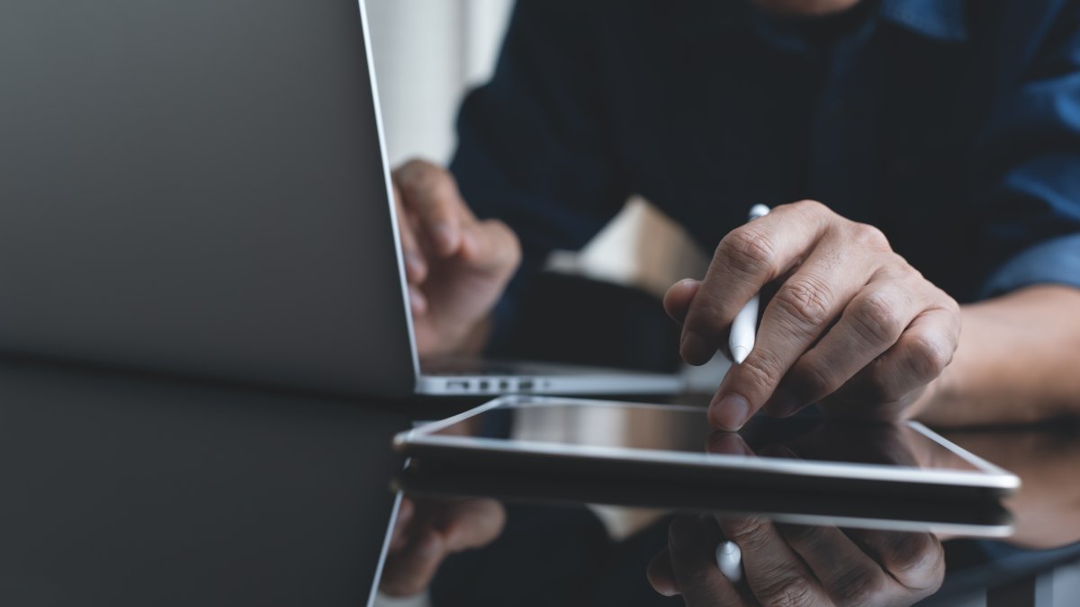A student studies using a laptop and tablet. (Shutterstock Photo)