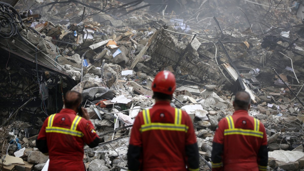 Rescue personnel work at a site destroyed by Israeli airstrikes, Tehran, Iran, March 23, 2026. (AA Photo)
