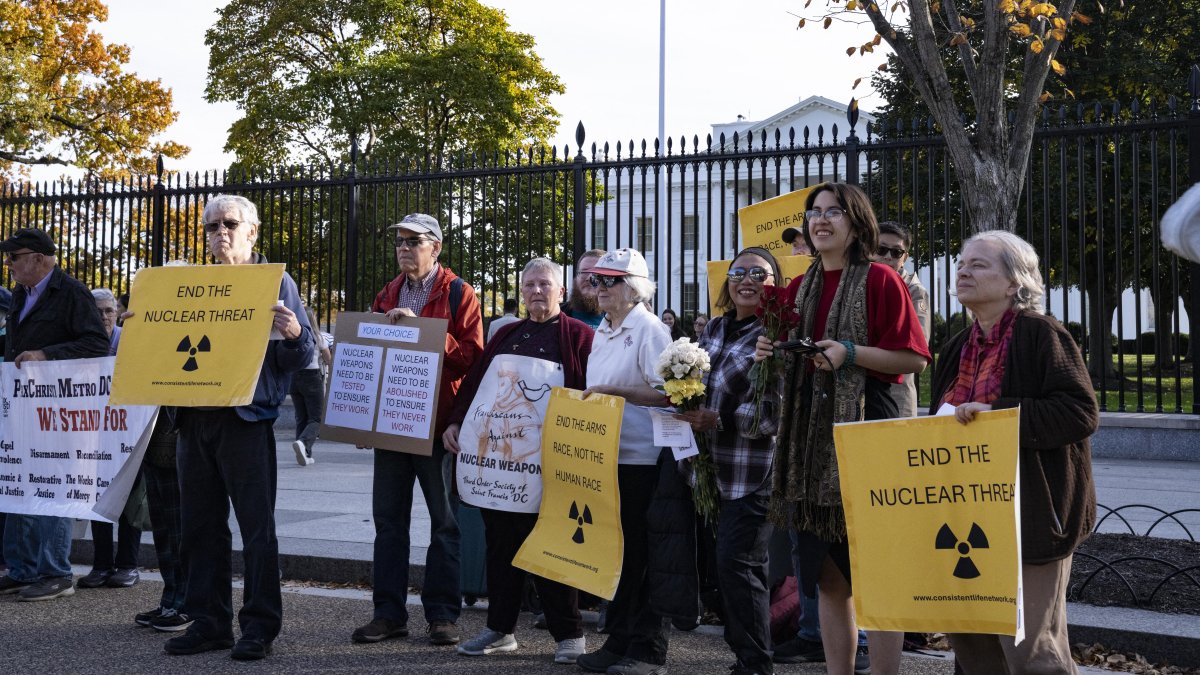 People protest against nuclear weapons outside the White House fence in Washington, D.C., Nov.  2, 2025. (NurPhoto via AFP, File) 
