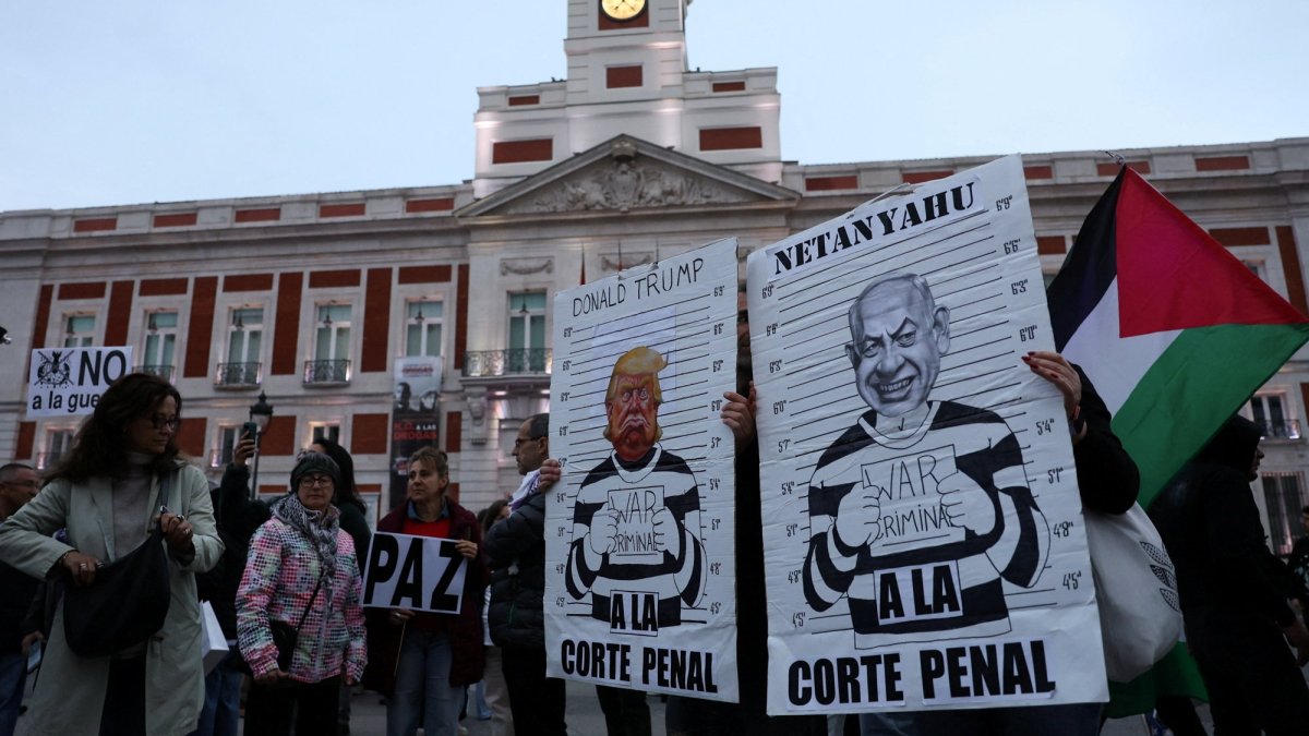 Protesters hold signs depicting U.S. President Donald Trump and Israeli Prime Minister Benjamin Netanyahu during a demonstration under the slogan "Down with Trump and Zionism" amid the U.S.-Israeli conflict with Iran, in Madrid, Spain, March 21, 2026. (Reuters Photo)