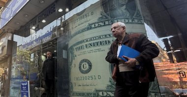 An Egyptian man walks past a currency exchange, Cairo, Egypt, March 9, 2026. (Reuters Photo)