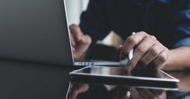 A student studies using a laptop and tablet. (Shutterstock Photo)