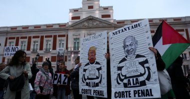 Protesters hold signs depicting U.S. President Donald Trump and Israeli Prime Minister Benjamin Netanyahu during a demonstration under the slogan "Down with Trump and Zionism" amid the U.S.-Israeli conflict with Iran, in Madrid, Spain, March 21, 2026. (Reuters Photo)