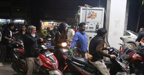 Motorcyclists wait to fetch fuel at a petrol pump in Srinagar, Kashmir, India, March 25, 2026. (EPA Photo)