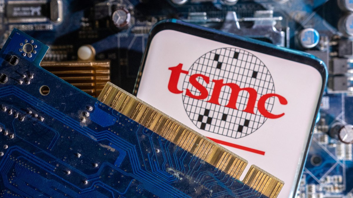 A smartphone with a displayed TSMC logo is placed on a computer motherboard in this illustration taken March 6, 2023. (Reuters Photo)