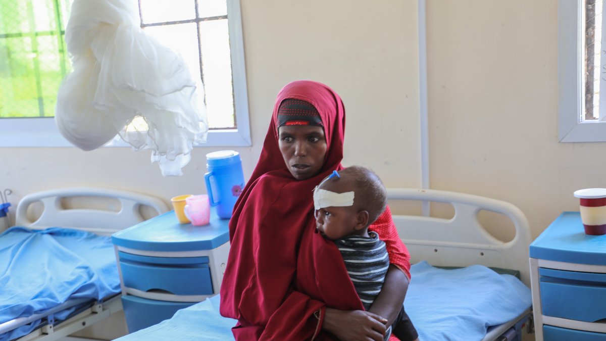 Isho Isak sits with her malnourished child at Dolow Referral Hospital in southern Somalia after being affected by drought, Dolow, Somalia, March 25, 2026 (AP Photo)