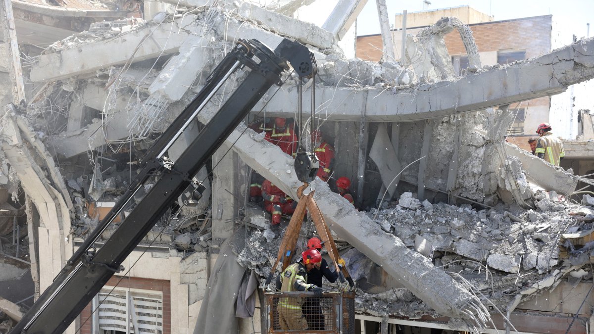 Iranian firefighters try to recover a body stuck under the rubble of a residential building, Tehran, Iran, March 27, 2026. (EPA Photo)
