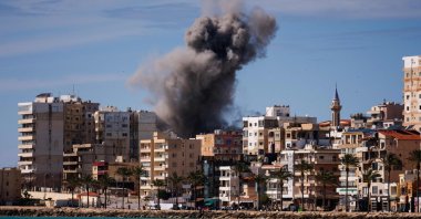 A plume of smoke and a fragment of concrete rise from the site of an Israeli airstrike on the eastern outskirts of Tyre, southern Lebanon, March 24, 2026. (AFP Photo)