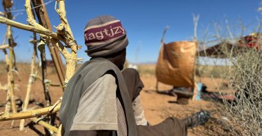 Sudanese displaced Abdullah Idris, who says he was imprisoned and tortured in Rapid Support Forces' (RSF) prisons before fleeing El-Fasher, sits at a makeshift shelter in the town of Tawila, Darfur, Sudan, March 2, 2026. (AFP Photo)