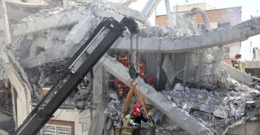 Iranian firefighters try to recover a body stuck under the rubble of a residential building, Tehran, Iran, March 27, 2026. (EPA Photo)