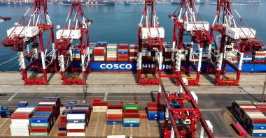 A cargo ship is docked at the foreign trade container terminal of Qingdao Port, Shandong, eastern China, March 25, 2026. (AFP Photo)