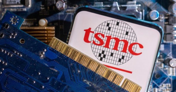 A smartphone with a displayed TSMC logo is placed on a computer motherboard in this illustration taken March 6, 2023. (Reuters Photo)