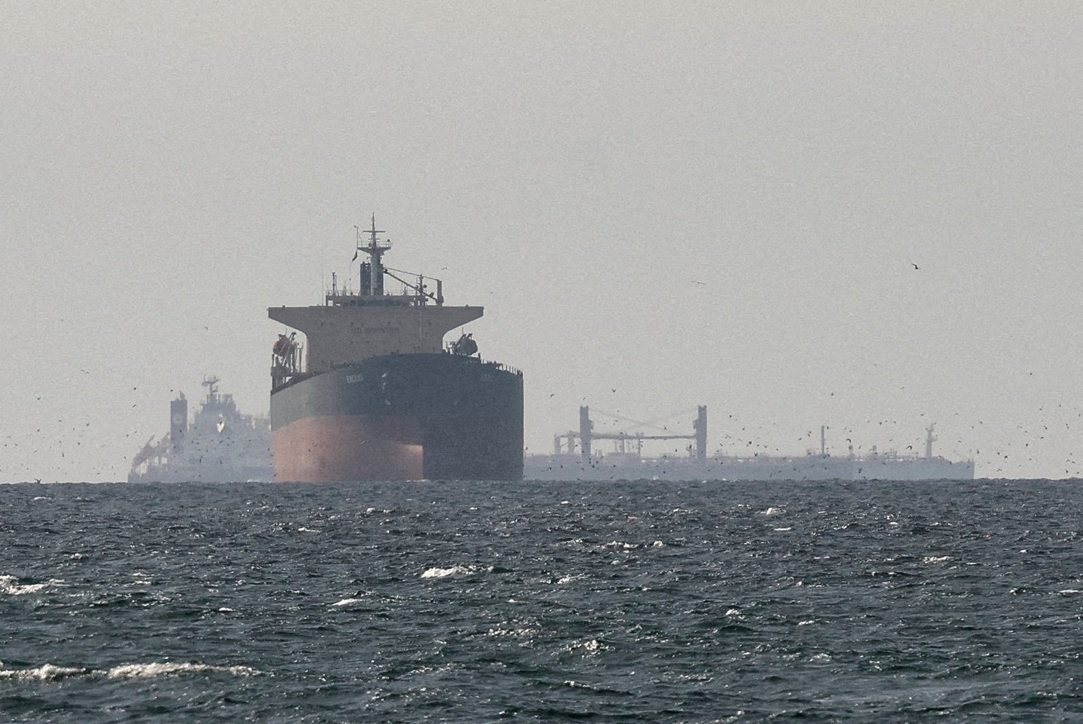 Cargo ships in the Gulf, near the Strait of Hormuz, as seen from northern Ras al-Khaimah, near the border with Oman’s Musandam governate, amid the U.S.-Israeli attacks on Iran, the United Arab Emirates (UAE), March 11, 2026. (Reuters Photo)