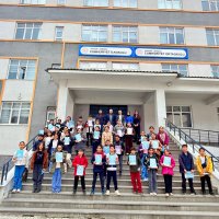 Students pose with their booklets after taking the reading contest exam at their school in eastern Hakkari province, Türkiye, March 29, 2026. (Photo Courtesy of TÜGVA)