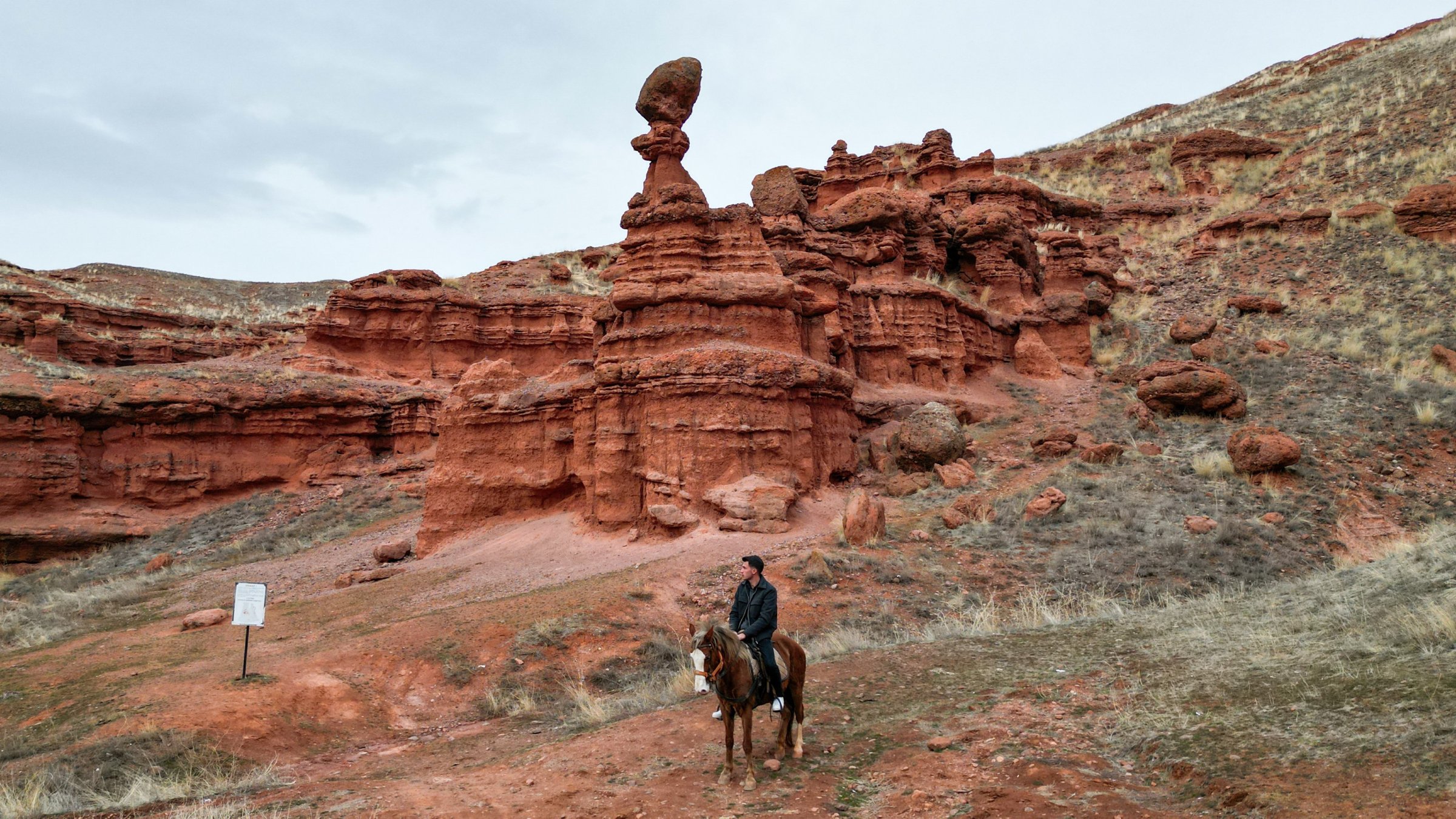 A visitor rides a horse through the red valleys of the Narman Fairy Chimneys, Erzurum, Türkiye, Feb. 17, 2026. (AA Photo) 