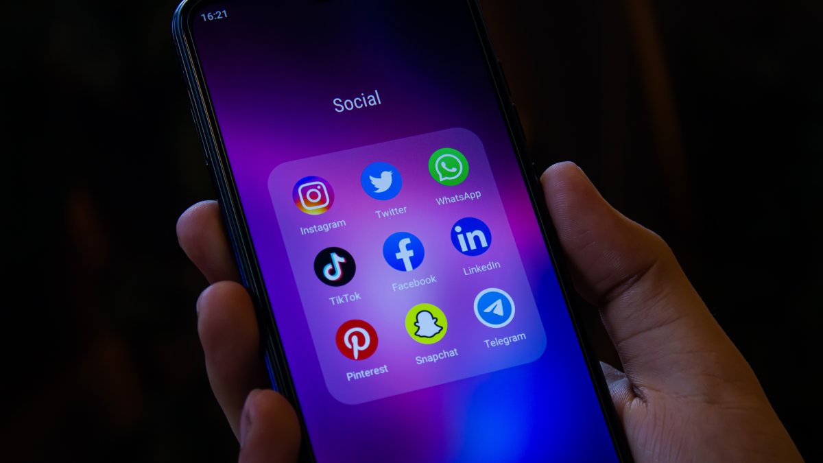 A smartphone home screen displays popular social media apps. (Shutterstock Photo)