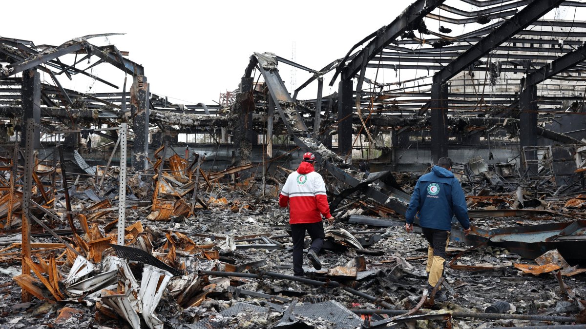 A member of the Iranian Red Crescent stands amid the wreckage of a building destroyed by U.S. and Israeli strikes, in Tehran, Iran, March 28, 2026. (EPA Photo)