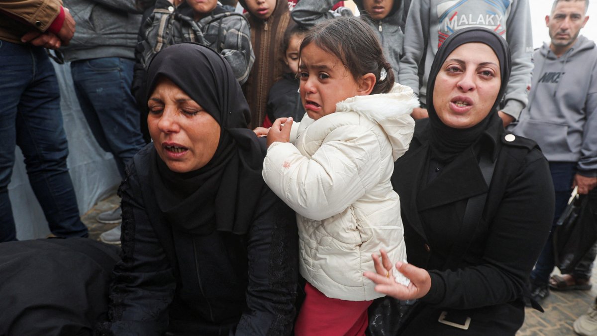 Mourners gather by the body during the funeral of six Palestinians, including three policemen, killed in Israeli strikes, in Khan Younis, southern Gaza Strip, Palestine, March 29, 2026. (Reuters Photo)