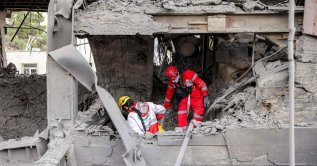 First responders search an office building that housed the offices of the Doha-headquartered news network Al Araby TV following a missile strike earlier in the day in Tehran, Iran, March 29, 2026. (AFP Photo)