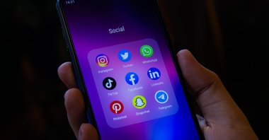 A smartphone home screen displays popular social media apps. (Shutterstock Photo)
