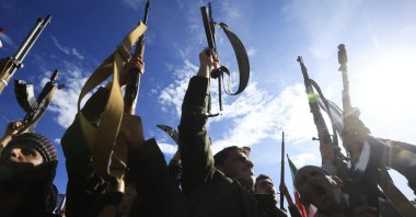 Houthi supporters shout slogans and raise their weapons during a rally in solidarity with Iran in Sana'a, Yemen, March 27, 2026. (EPA Photo)