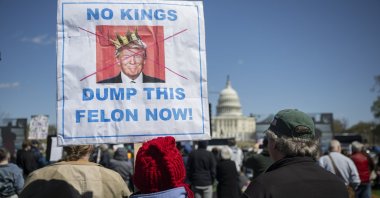 People hold signs during a national "No Kings" protest against President Donald Trump, Washington, D.C., U.S., March 28, 2026.