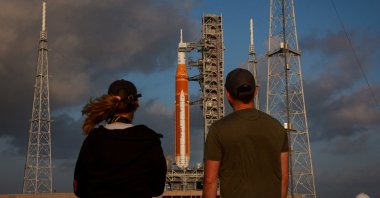 People look at NASA's next-generation moon rocket, the Space Launch System (SLS) rocket with the Orion crew capsule, on Pad 39B ahead of the Artemis II mission launch at the Kennedy Space Center in Cape Canaveral, Florida, U.S., March 29, 2026. (Reuters Photo)