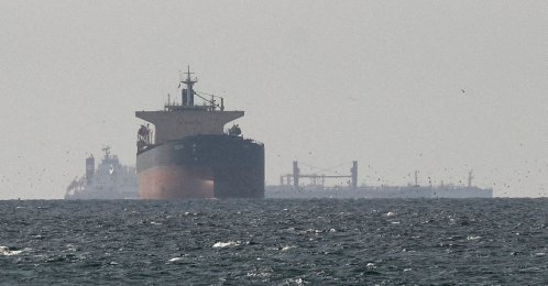 Cargo ships in the Gulf, near the Strait of Hormuz, as seen from northern Ras al-Khaimah, near the border with Oman’s Musandam governate, amid the U.S.-Israeli attacks on Iran, the United Arab Emirates (UAE), March 11, 2026. (Reuters Photo)