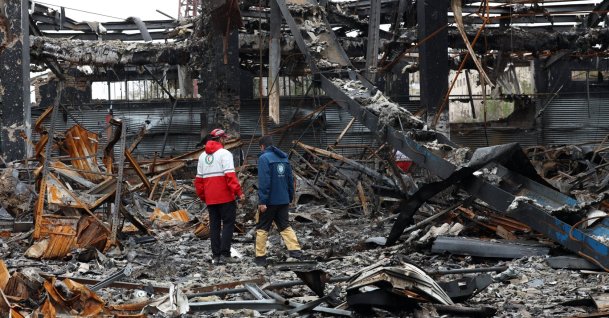 Members of the Iranian Red Crescent stand amid the wreckage of vehicles at an auto service center, Tehran, Iran, March 28, 2026. (EPA Photo)