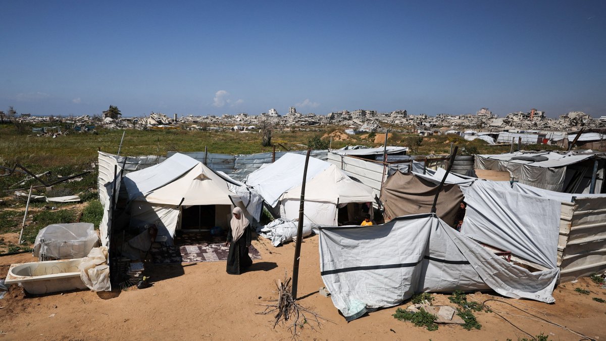 Umm Yousef Dahdouh, a displaced Palestinian mother of three prisoners held by Israel, stands in front of her tent in Gaza City, March 30, 2026. (Reuters Photo)