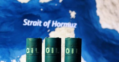 A map showing the Strait of Hormuz and 3D printed oil barrels are seen in this illustration taken March 23, 2026. (Reuters Photo)