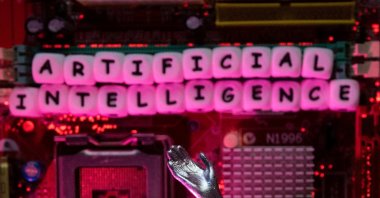 AI (Artificial Intelligence) letters and robot hand are placed on computer motherboard in this illustration taken, June 23, 2023. (Reuters Photo)