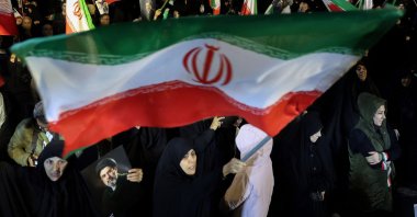 People wave national flags and hold portraits of Iran's Supreme Leader Mojtaba Khamenei as they march in Tehran, Iran, March 25, 2026.  (AFP Photo)