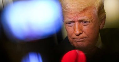 U.S. President Donald Trump looks on as he speaks to members of the media aboard Air Force One en route to Joint Base Andrews, Maryland, U.S., March 29, 2026. (Reuters Photo)