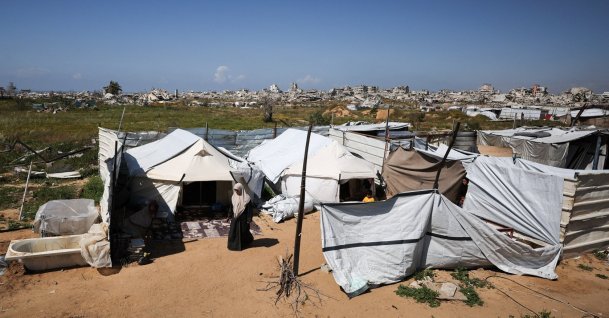 Umm Yousef Dahdouh, a displaced Palestinian mother of three prisoners held by Israel, stands in front of her tent in Gaza City, March 30, 2026. (Reuters Photo)