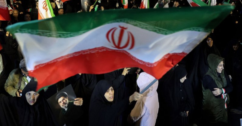 People wave national flags and hold portraits of Iran's Supreme Leader Mojtaba Khamenei as they march in Tehran, Iran, March 25, 2026.  (AFP Photo)