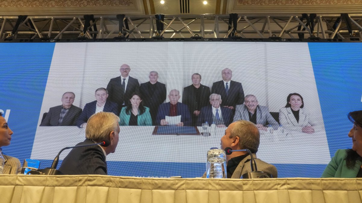 A DEM Party delegation attends a news conference with the PKK's jailed leader Abdullah Öcalan, seen in the center in the background photo, Istanbul, Türkiye, Feb. 27, 2025. (AP Photo)