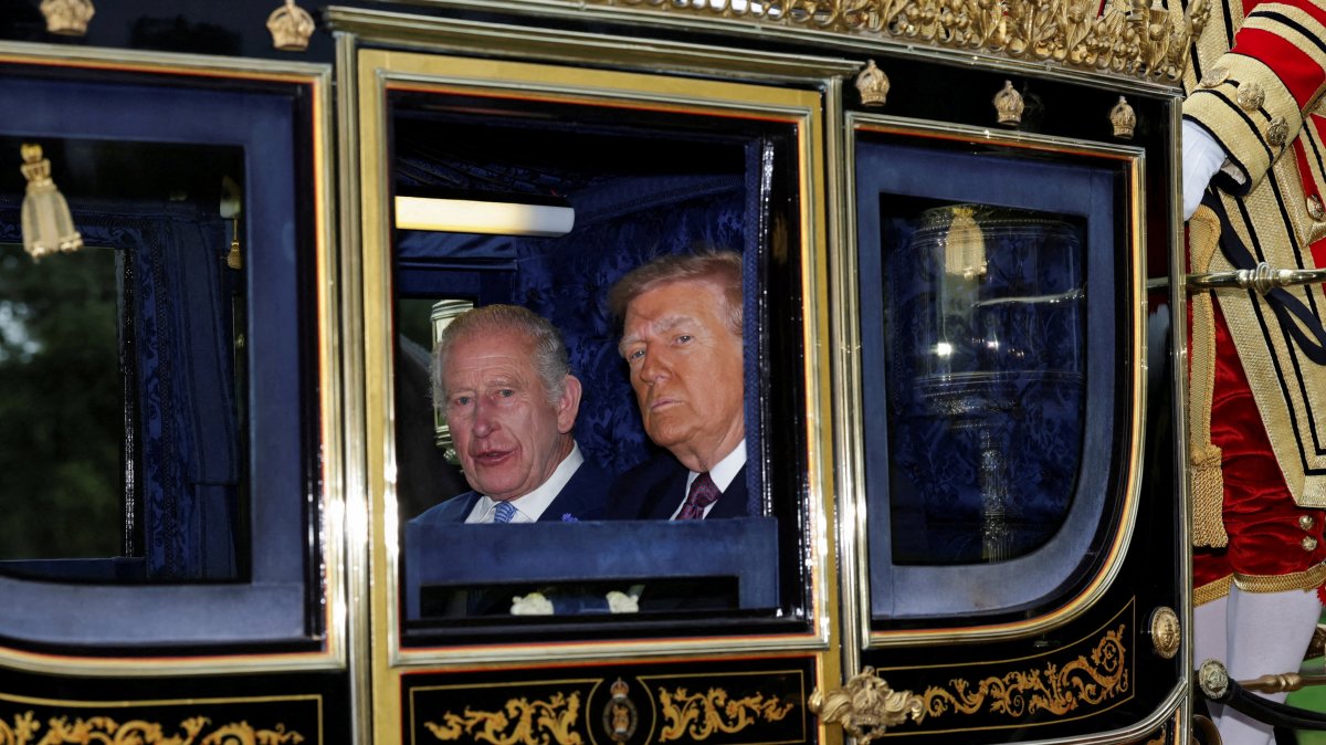 Britain's King Charles and U.S. President Donald Trump sit in a carriage during a procession through Windsor Castle, in Windsor, Britain, Sept. 17, 2025. (Reuters Photo)