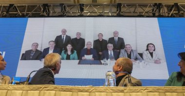 A DEM Party delegation attends a news conference with the PKK's jailed leader Abdullah Öcalan, seen in the center in the background photo, Istanbul, Türkiye, Feb. 27, 2025. (AP Photo)
