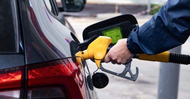 A motorist takes a Gazol fuel pump to fill up his car at a gas station in Marseille, southern France, March 10, 2026. (AFP Photo)
