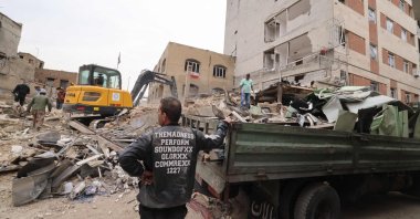 A digger removes the debris following damage to a residential building in the Iranian capital Tehran, March 15, 2026. (AFP File Photo)